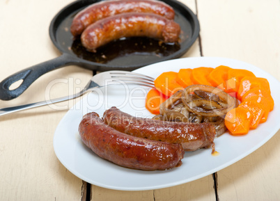 beef sausages cooked on iron skillet