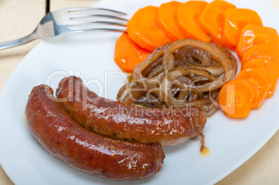 beef sausages cooked on iron skillet