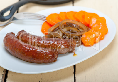 beef sausages cooked on iron skillet