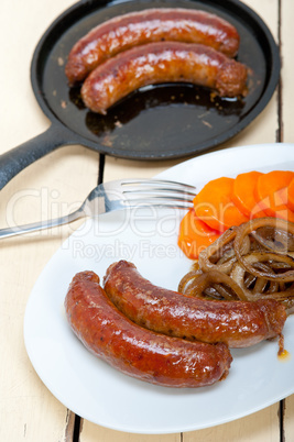 beef sausages cooked on iron skillet