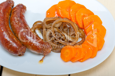 beef sausages cooked on iron skillet