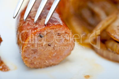 beef sausages cooked on iron skillet