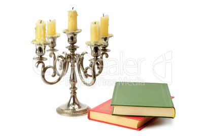 candlestick and books isolated on white background