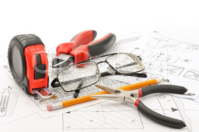 Tools and glasses on the drawing