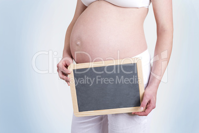 Pregnant woman with an empty blackboard