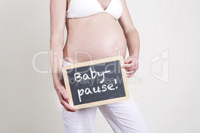 Pregnant woman with an empty blackboard