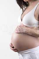 Pregnant woman in front of a white background