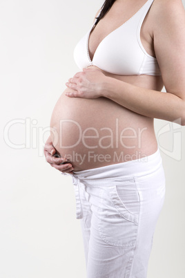 Pregnant woman in front of a white background