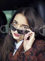 Young pretty girl sitting behind the wheel of a car