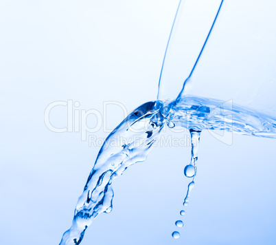 Cool Water Pouring from a Transparent Glass Cup