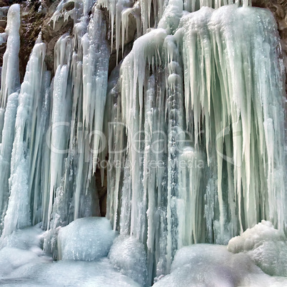 frozen small mountain waterfall close up