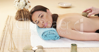 Pretty woman enjoying a lava stone massage