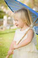 Cute Baby Girl Holding Parasol Outside At Park