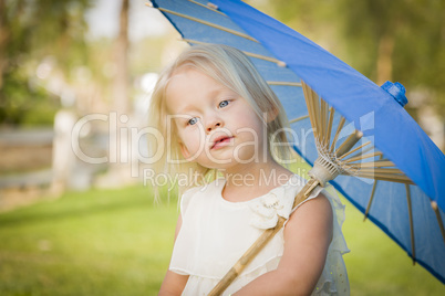 Cute Baby Girl Holding Parasol Outside At Park