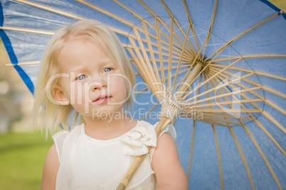 Cute Baby Girl Holding Parasol Outside At Park