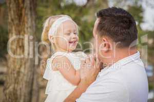 Father Playing With Cute Baby Girl Outside at the Park