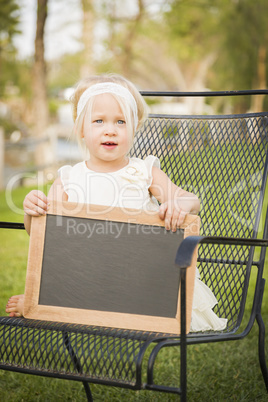 Cute Baby Girl in Chair Holding Blank Blackboard
