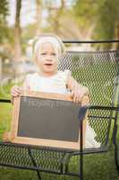 Cute Baby Girl in Chair Holding Blank Blackboard