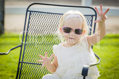 Cute Playful Baby Girl Wearing Sunglasses Outside at Park