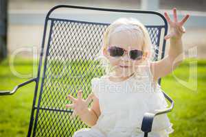Cute Playful Baby Girl Wearing Sunglasses Outside at Park
