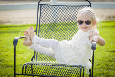 Cute Playful Baby Girl Wearing Sunglasses Outside at Park