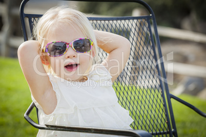 Cute Playful Baby Girl Wearing Sunglasses Outside at Park