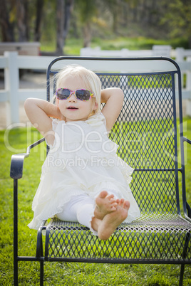 Cute Playful Baby Girl Wearing Sunglasses Outside at Park