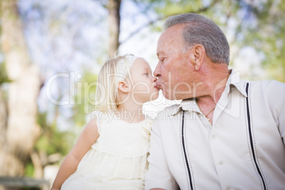 Grandfather and Granddaughter Kissing At The Park