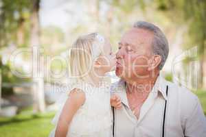 Grandfather and Granddaughter Kissing At The Park