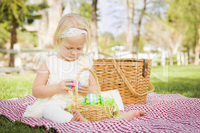 Cute Baby Girl Enjoying Her Easter Eggs on Picnic Blanket