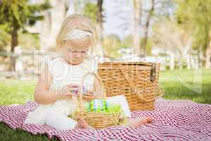Cute Baby Girl Enjoying Her Easter Eggs on Picnic Blanket