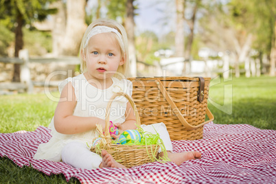 Cute Baby Girl Enjoying Her Easter Eggs on Picnic Blanket