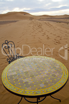 table and seat in sand