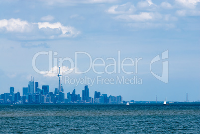 Toronto city skyline across water under clouds