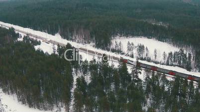 Flying Above Winter Forest and Railroad, aerial view