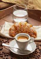 Espresso with croissant and glass of water