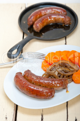 beef sausages cooked on iron skillet