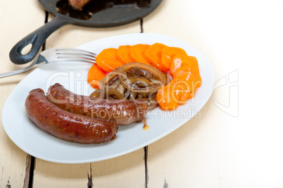 beef sausages cooked on iron skillet