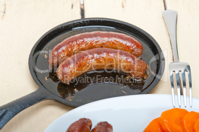 beef sausages cooked on iron skillet