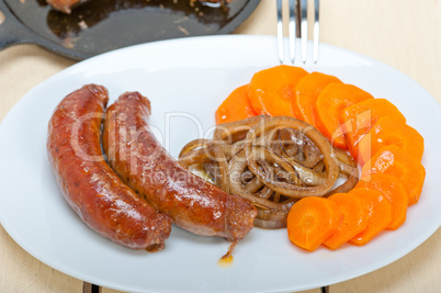 beef sausages cooked on iron skillet