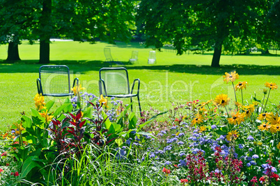 Chaise lounge for recreation near flowerbed