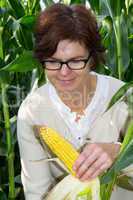Women farmers controls his corn field