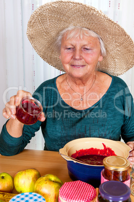 One Mature woman with straw hat and homemade jam