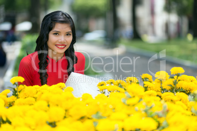 Attractive Vietnamese woman with yellow flowers