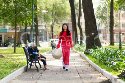 Elegant young Vietnamese woman in a park