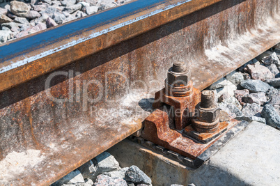 Railroad nut and bolt on background of gravel