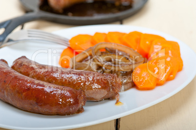 beef sausages cooked on iron skillet