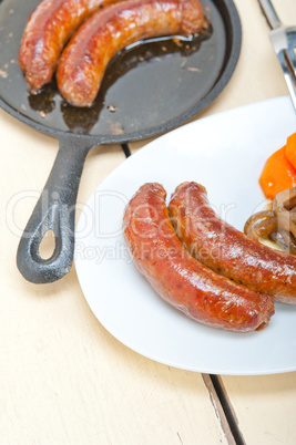 beef sausages cooked on iron skillet