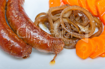 beef sausages cooked on iron skillet