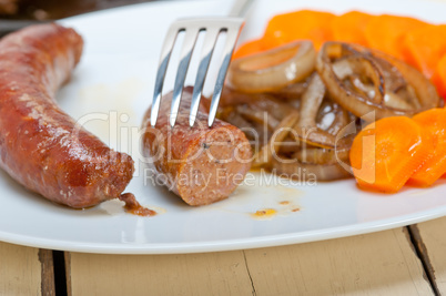 beef sausages cooked on iron skillet